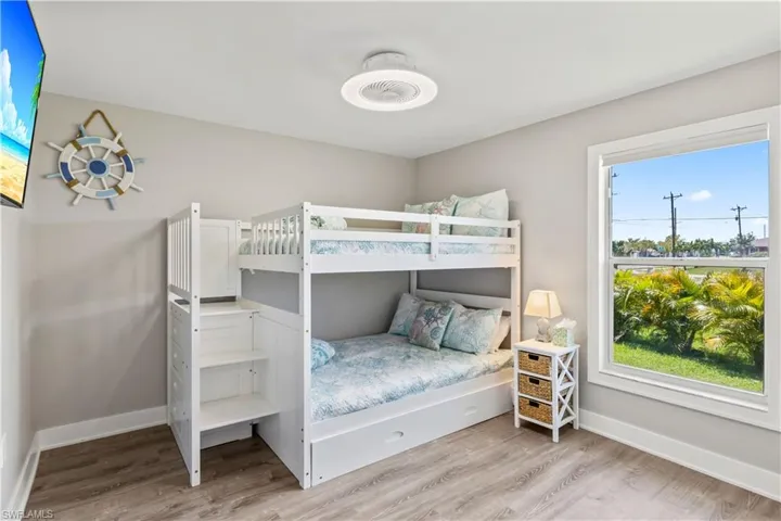 Bedroom with baseboards and wood finished floors
