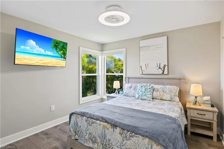 Bedroom with baseboards and dark wood finished floors