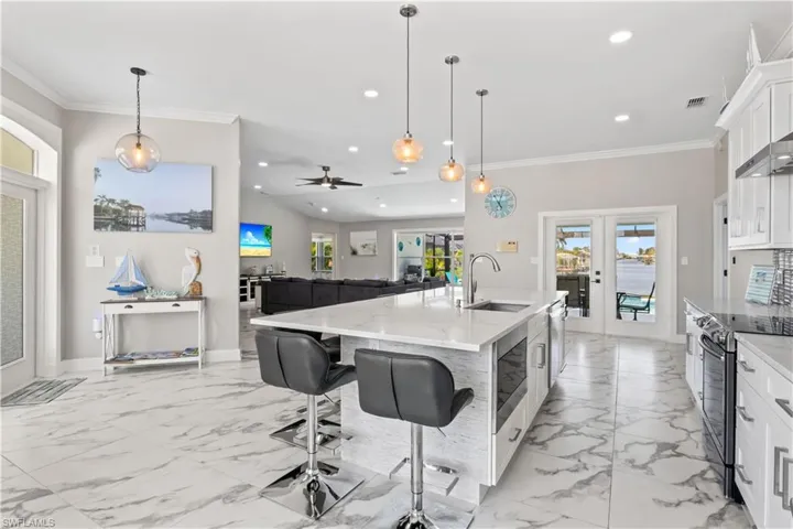 Kitchen with stainless steel appliances, recessed lighting, a sink, and crown molding