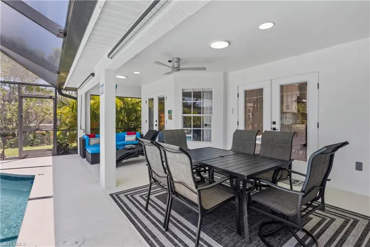 View of patio featuring an outdoor hangout area, an outdoor pool, a ceiling fan, a lanai, and french doors
