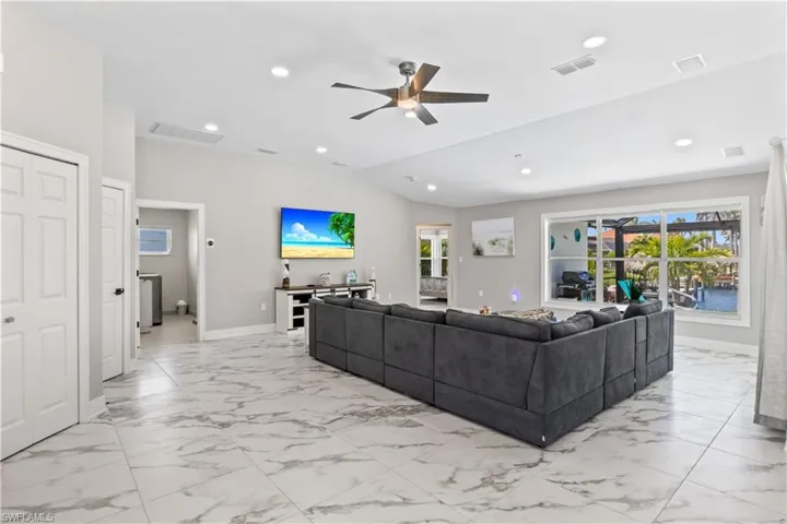 Living area featuring marble finish floor, ceiling fan, visible vents, and recessed lighting