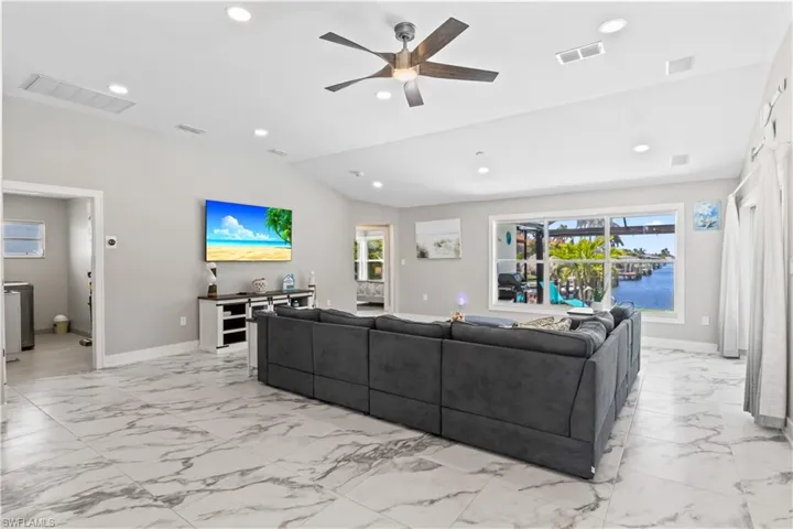 Living room with marble finish floor and visible vents