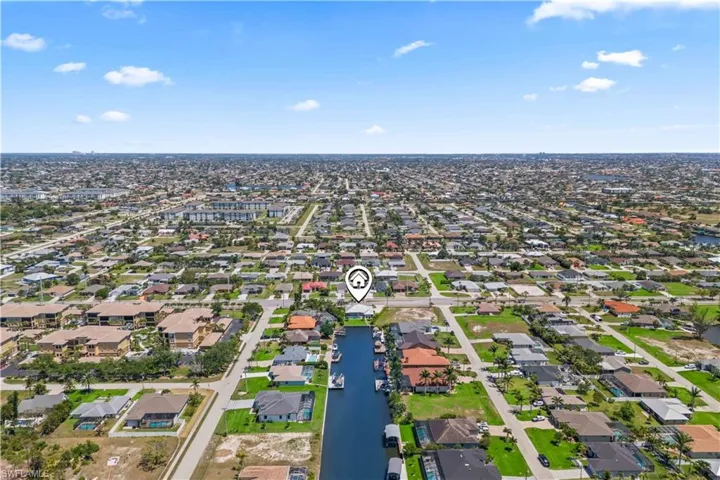 Birds eye view of property with a water view and a residential view