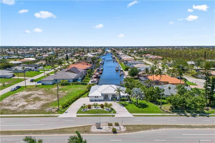 Drone / aerial view with a residential view and a water view