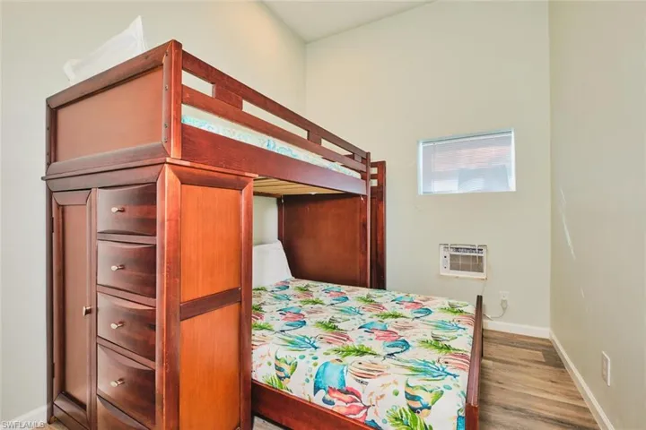 Bedroom 1 of apartment on first  level with baseboards and light wood finished floors