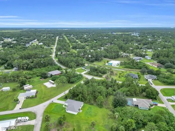 Aerial view of property's location featuring nearby suburban area