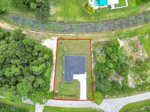 Aerial view of property and surrounding area with property parcel outlined