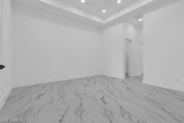 Spare room with recessed lighting and a tray ceiling