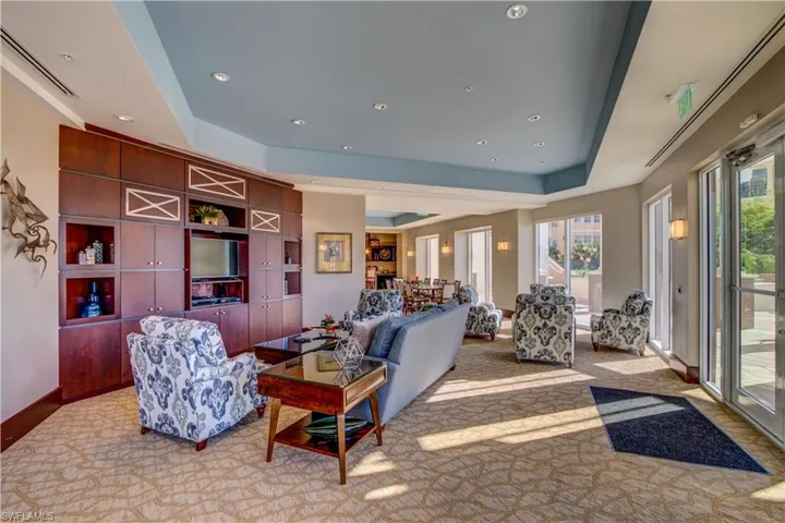 Living room with plenty of natural light and a tray ceiling