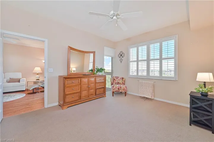 Sitting room with a ceiling fan, carpet floors, and baseboards
