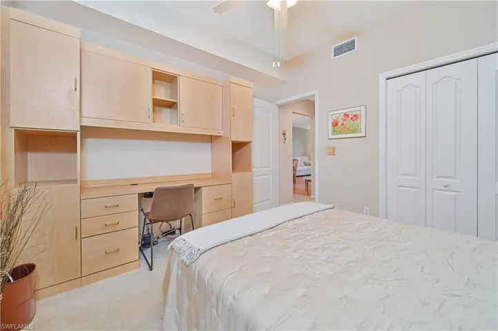 Bedroom with light colored carpet, a closet, and ceiling fan