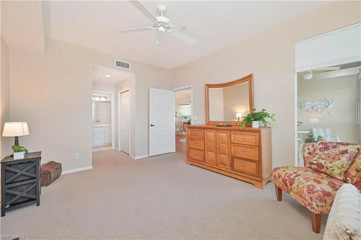 Sitting room with ceiling fan, carpet floors, and baseboards