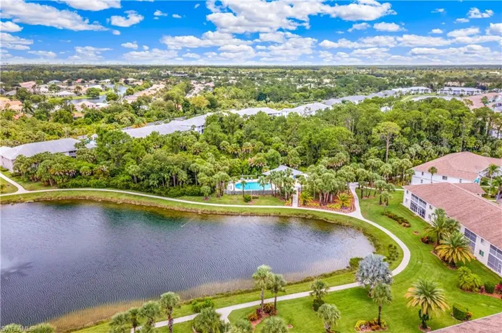 Aerial view of lake, pool, and community