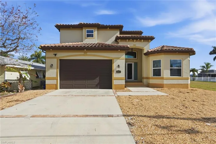 Mediterranean / spanish-style home featuring driveway, a garage, stucco siding, and a tile roof