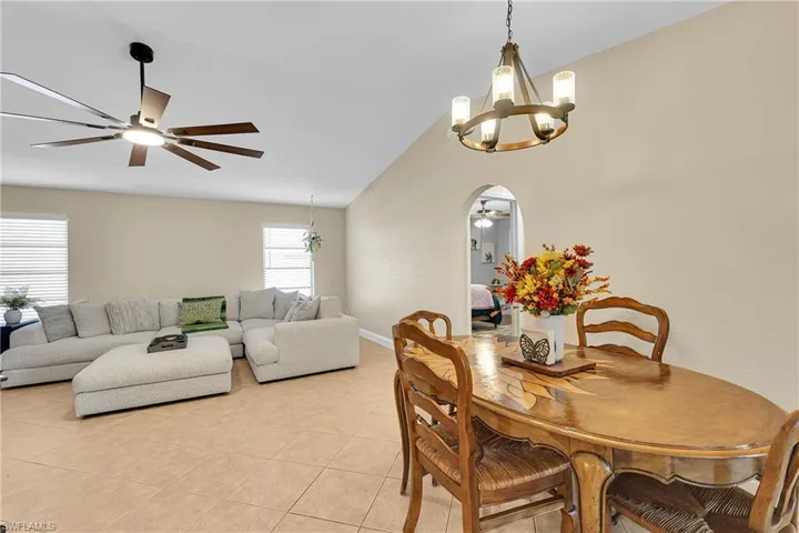 Living area with light tile patterned flooring and a ceiling fan