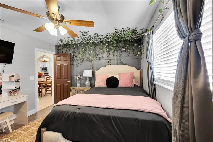 Bedroom featuring a ceiling fan, light wood finished floors, a closet, and a textured ceiling