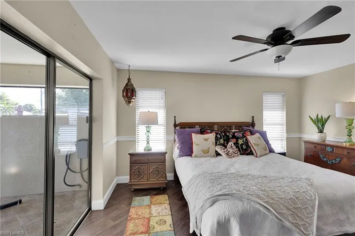 Bedroom featuring wood finished floors, ceiling fan, and access to exterior