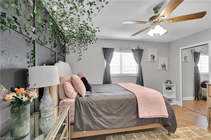 Bedroom with a ceiling fan and a chandelier