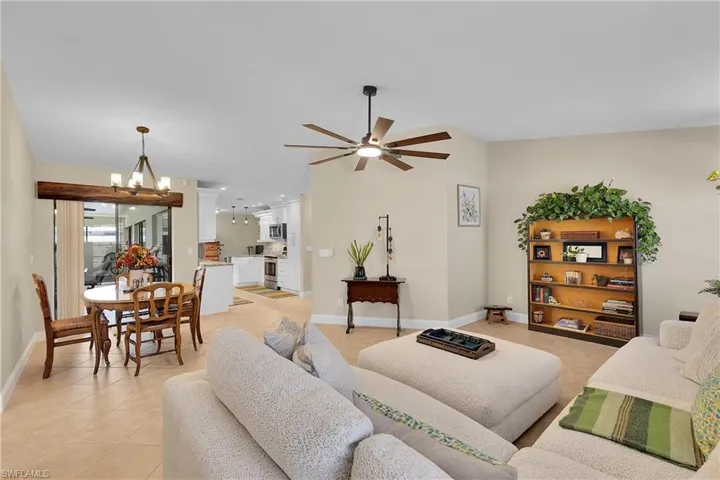Living area featuring light tile patterned flooring and ceiling fan