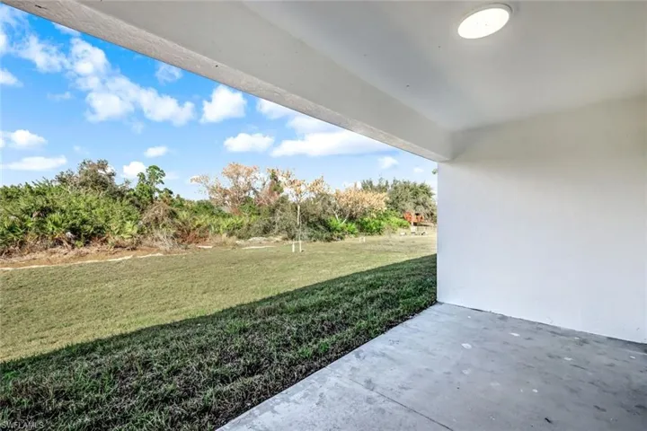 Shaded outdoor patio space overlooking the backyard—perfect for morning coffee or evening relaxation.