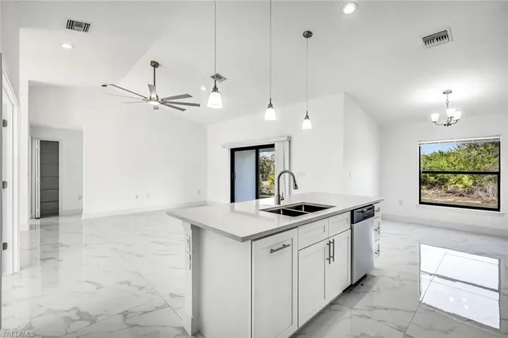 Another angle highlighting the island and open concept, with bright finishes and plenty of room for gatherings.