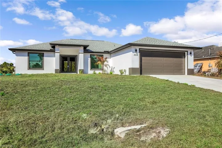 Final curb appeal shot highlighting the home’s clean lines, driveway space, and inviting entry.