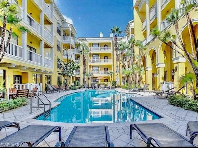 Community pool with a patio