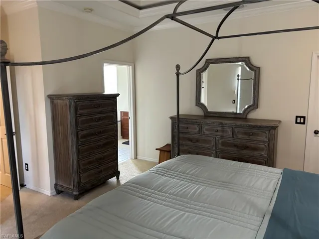 Bedroom featuring light carpet and crown molding