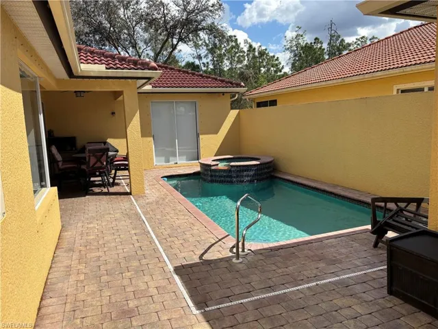 Combined pool / hot tub with a patio