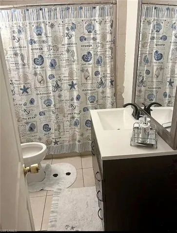 Bathroom with vanity and light tile patterned floors