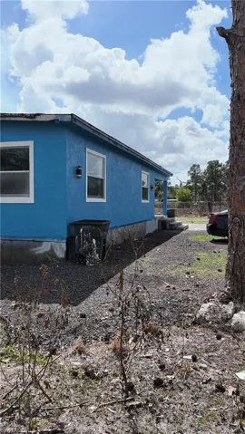 View of side of property featuring stucco siding