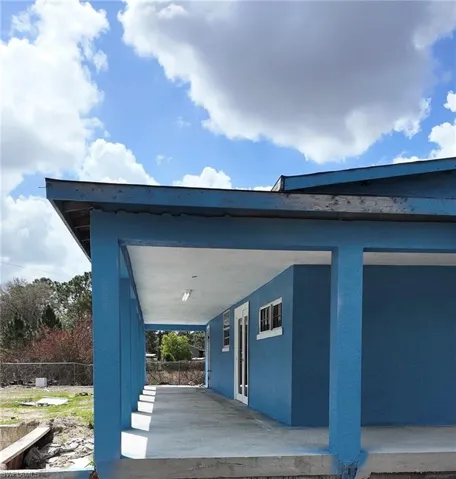 View of property exterior with stucco siding and a patio