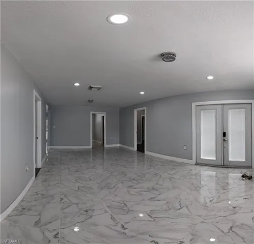 Spare room featuring french doors and recessed lighting