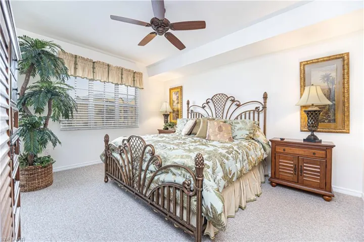 Carpeted bedroom featuring baseboards and a ceiling fan
