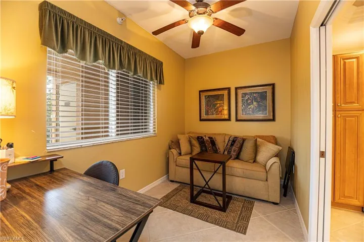 Office featuring light tile patterned flooring and ceiling fan