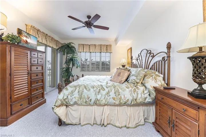 Bedroom featuring light carpet and a ceiling fan