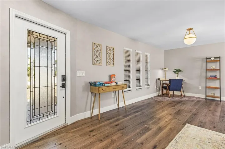 Entryway featuring baseboards and wood finished floors