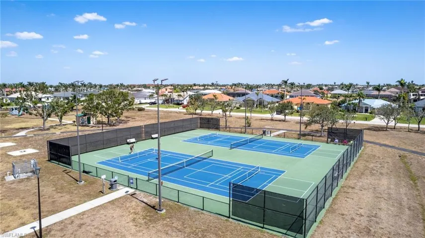 View of sport court with fence and a residential view