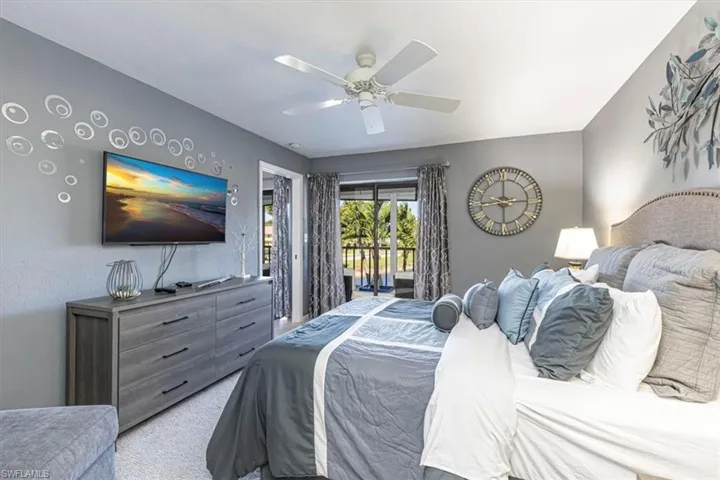Bedroom featuring access to outside, carpet, and ceiling fan