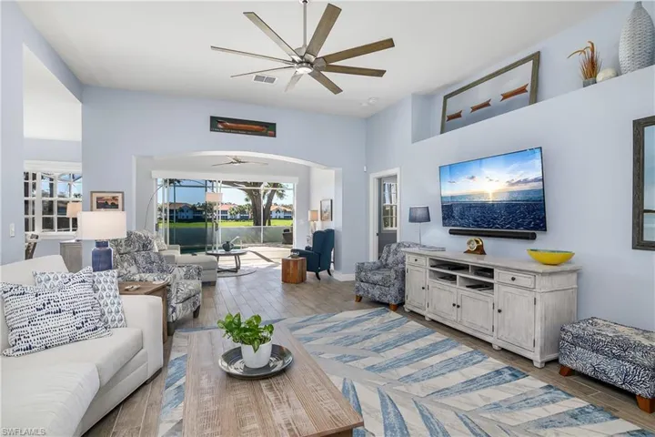 Beautifully furnished great room with new ceiling fan, sliding glass doors to large lanai and view of fairway #13, south golf course. Open area at upper left is entry to kitchen and dining area...door at upper right is entry to master bedroom suite. All furnishings are available for negotiation to purchase. Move-in ready!