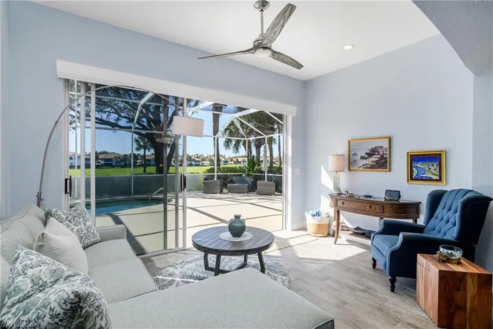Additional sunroom living area, new ceiling fan, sliders to lanai. Entire "open area" has a Hunter-Douglas battery powered ceiling to floor shade for privacy.