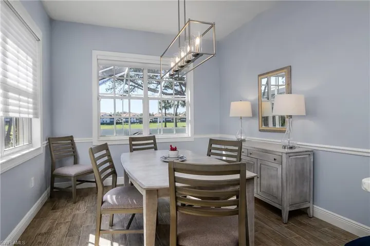 Dining area featuring plenty of natural light, Hunter-Douglas shades and modern chandelier