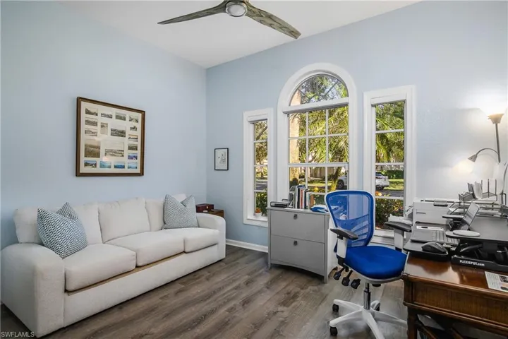 Street side combination guest bedroom (sleep sofa) and den. Your choice to maintain current flexibility or furnish as a complete bedroom or den. Hunter-Douglas shades are at windows. Note ceiling fan.