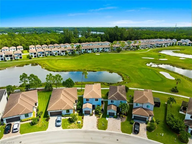 Aerial view of residential area with a large body of water and a golf club