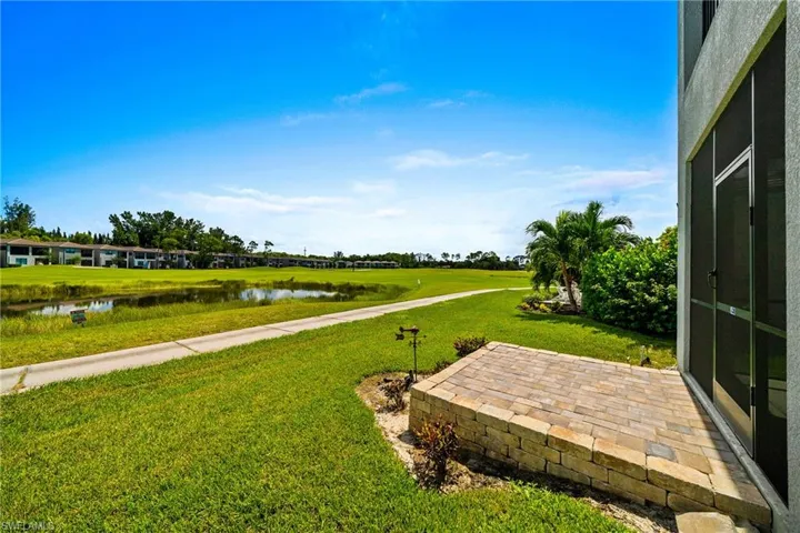 View of green lawn featuring a water view