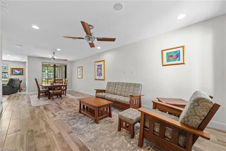 Living area featuring light wood-style flooring, recessed lighting, and ceiling fan