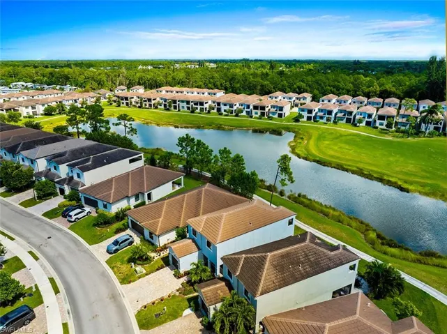 Aerial perspective of suburban area featuring a large body of water
