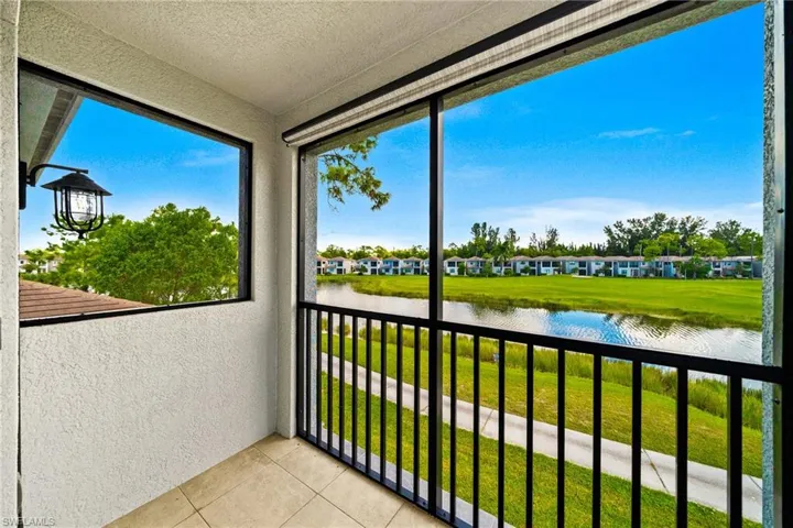 Balcony featuring a water view and a sunroom