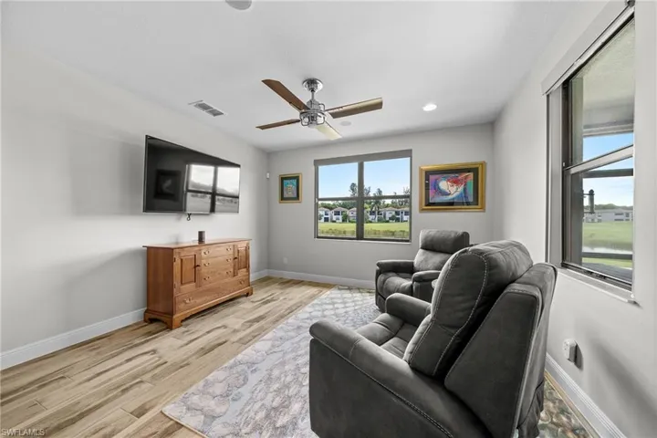 Living area with a ceiling fan, light wood-type flooring, and recessed lighting