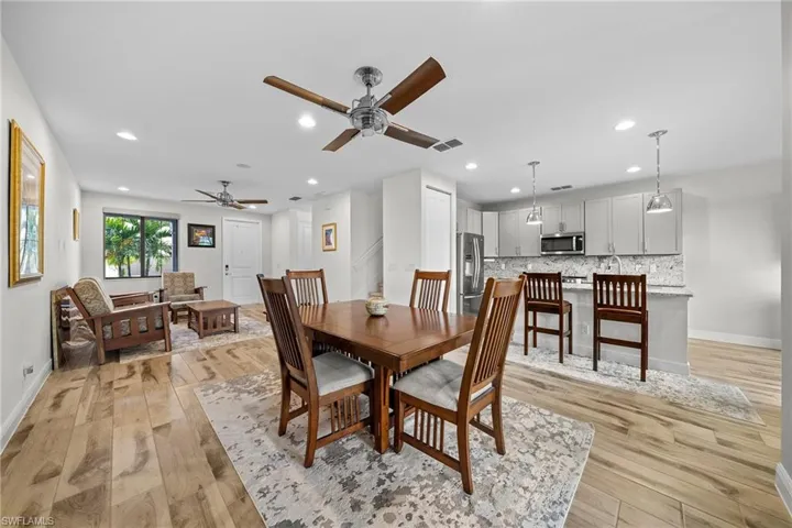 Dining space featuring light wood-style flooring, recessed lighting, stairway, and a ceiling fan